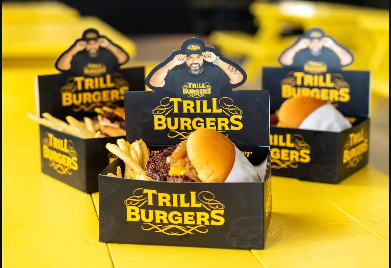 Trill Burgers combo boxes on a yellow picnic table